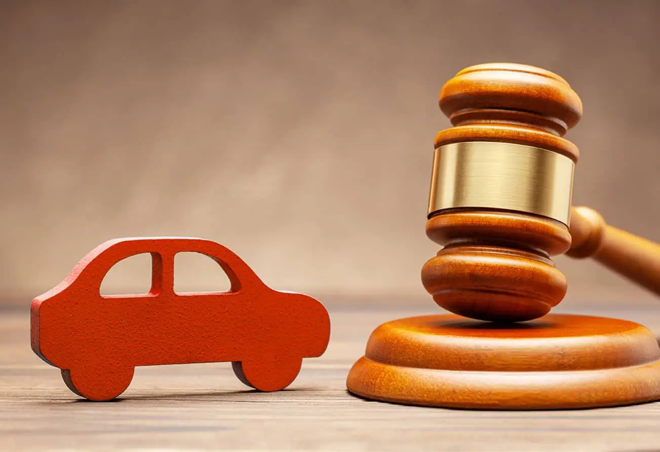 wooden car figure and judges' gavel