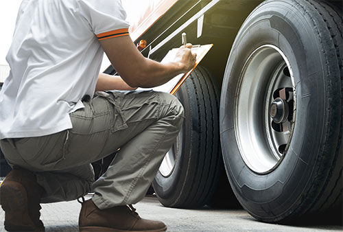 Semi truck being inspected to prevent fatal truck accident